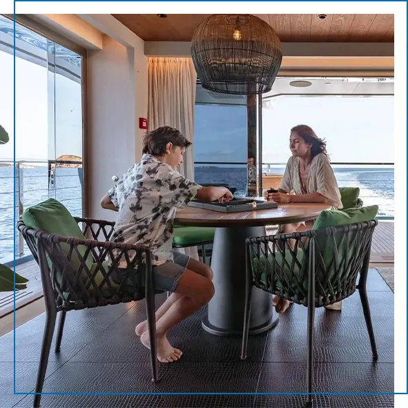 superyacht-charter-guests-enjoying-an-interior-space-with-ocean-breeze-on-MY-King-Benji