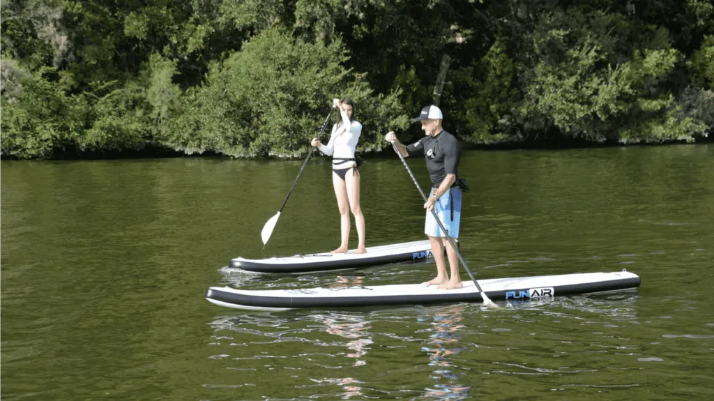 Man and Woman on FunAir Inflatable SUPS on a river