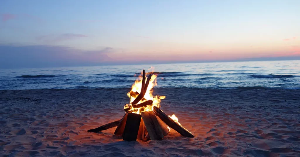 a campfire on a beach on a caribbean island during a superyacht beach excursion