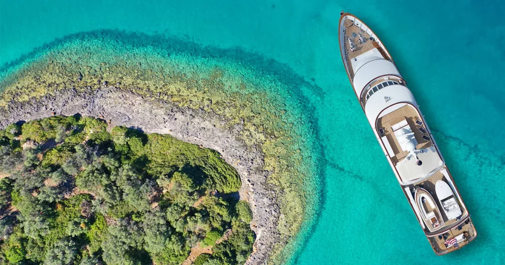 drone shot of a luxury charter superyacht in a provate anchorage in the caribbean