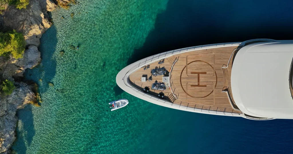 drone view of a charter yacht ancjored in the azure water of the caribbean